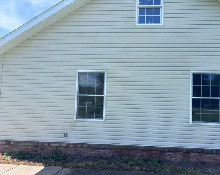 The same wall after washing, the siding clean and even in colour.